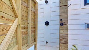 A wooden fence with a door, a window, and a mailbox. - Brezza Fresca w/ a private pool In Carolina Beach (Wilmington)