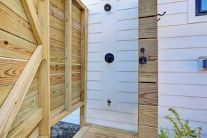 A wooden fence with a door, a window, and a mailbox. - Brezza Fresca w/ a private pool In Carolina Beach (Wilmington)