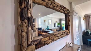 A rustic stone-framed mirror in a modern kitchen with a built-in stove, a coffee maker, and a TV on the wall. - Air-conditioned apartment with sea view - Les Restanques SWIMMING POOLS TENNIS (Grimaud)