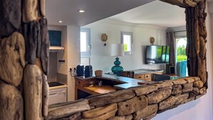 A modern kitchen with a stone-framed mirror, a built-in oven, and a wooden countertop. - Air-conditioned apartment with sea view - Les Restanques SWIMMING POOLS TENNIS (Grimaud)