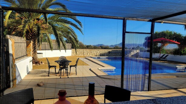 A poolside area with a covered patio, outdoor seating, and a view of a swimming pool. - Casita-1 To 5guests-pool-patio-bbq-parking (Huercal-Overa)