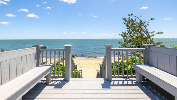 A wooden deck leading to a beach with a clear view of the ocean. - Paradise Awaits you!  Sleeping 14, this oceanfront complex is perfect! (Dennis Port)