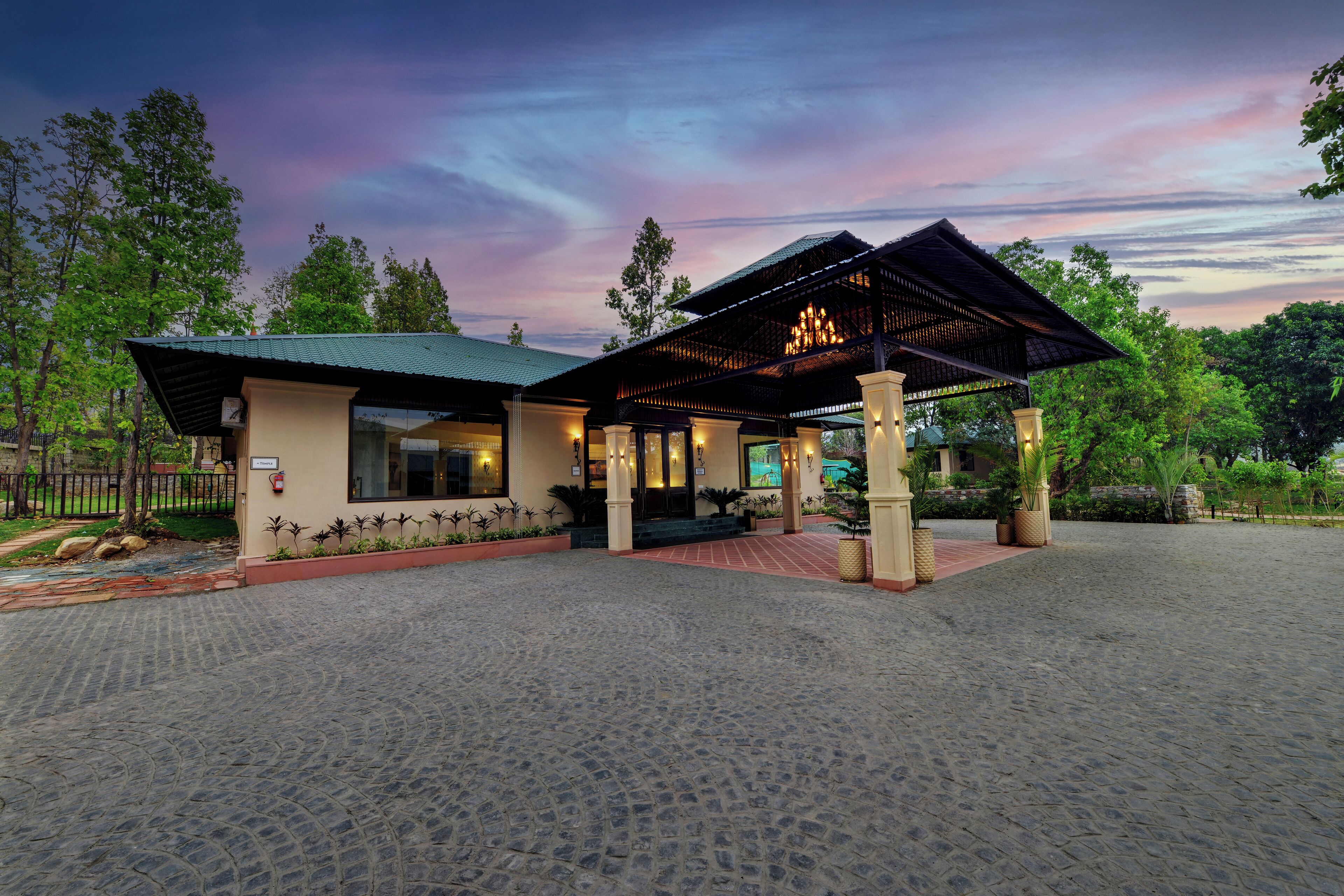 A building with a covered entrance and a paved courtyard.