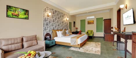 A hotel room with a sofa, a bed, a desk, and a dining table.