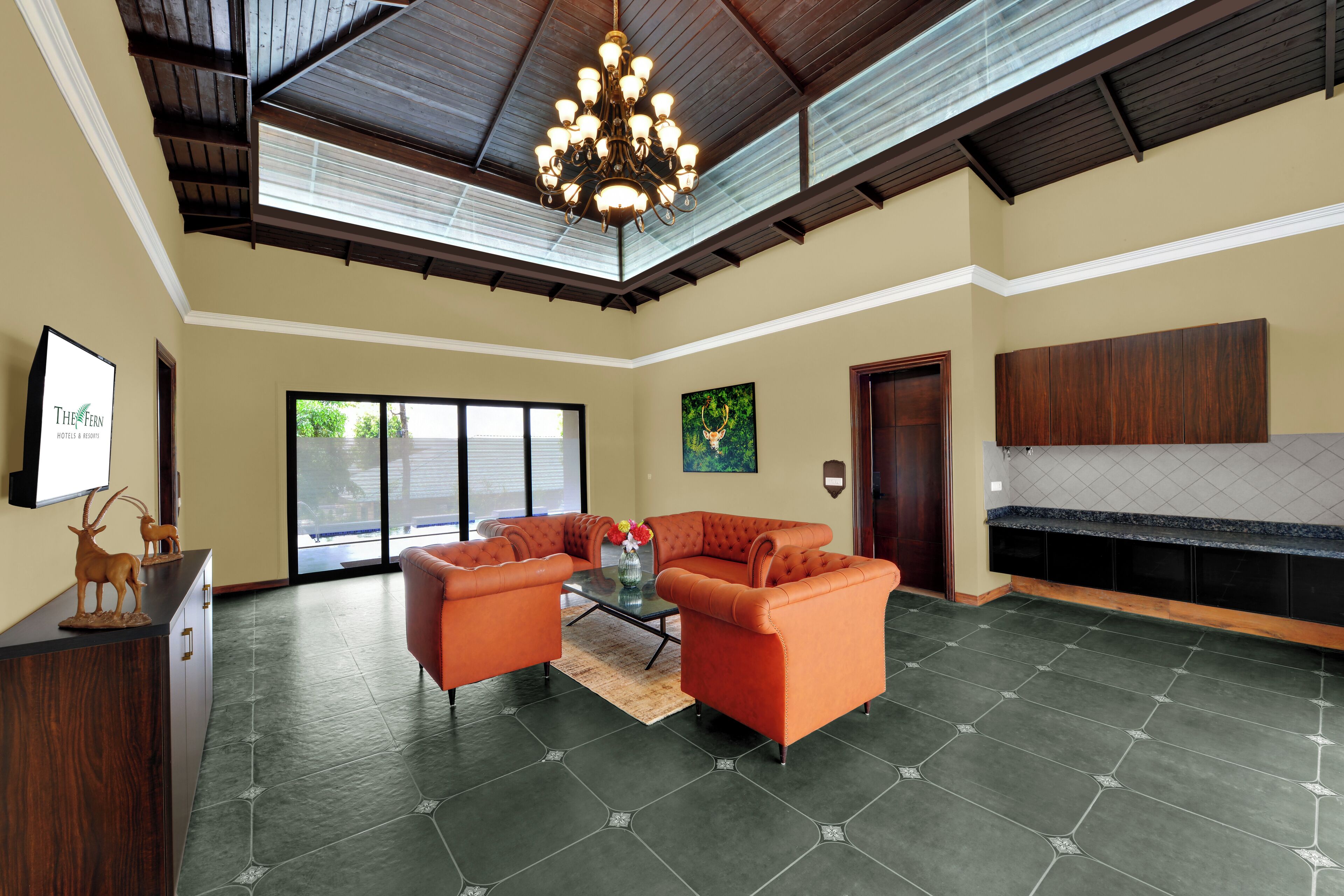 A spacious living area with a high ceiling, a chandelier, and a fireplace.