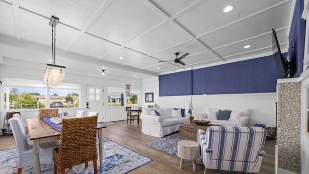 A spacious living area with a dining table, chairs, sofas, and a ceiling fan. - Game Room, Dogs Ok, Walk to Beach (Breakaway) (Ocean Park)