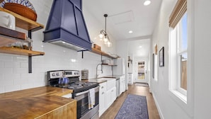 A modern kitchen with white subway tiles, stainless steel appliances, and wooden countertops. - Game Room, Dogs Ok, Walk to Beach (Breakaway) (Ocean Park)