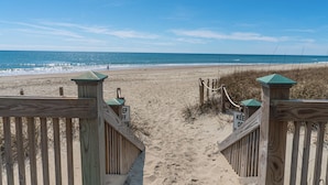 A wooden beach gate leading to a sandy beach with a clear view of the ocean. - Beachwalk 105, Oceanfront Condo in Pine Knoll Shores, NC! (Pine Knoll Shores)