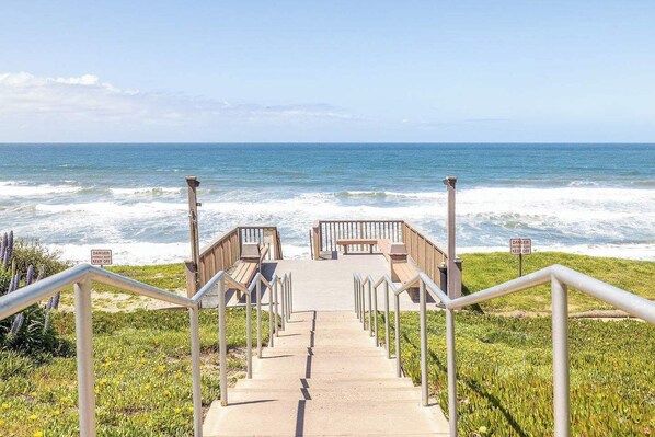 A concrete staircase leading to a wooden deck overlooking the ocean with safety signs. - Sea Bluff - Direct Beach Access (Encinitas)