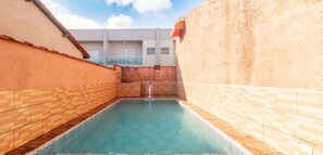 Relax by the pool surrounded by a unique brick and tile design.