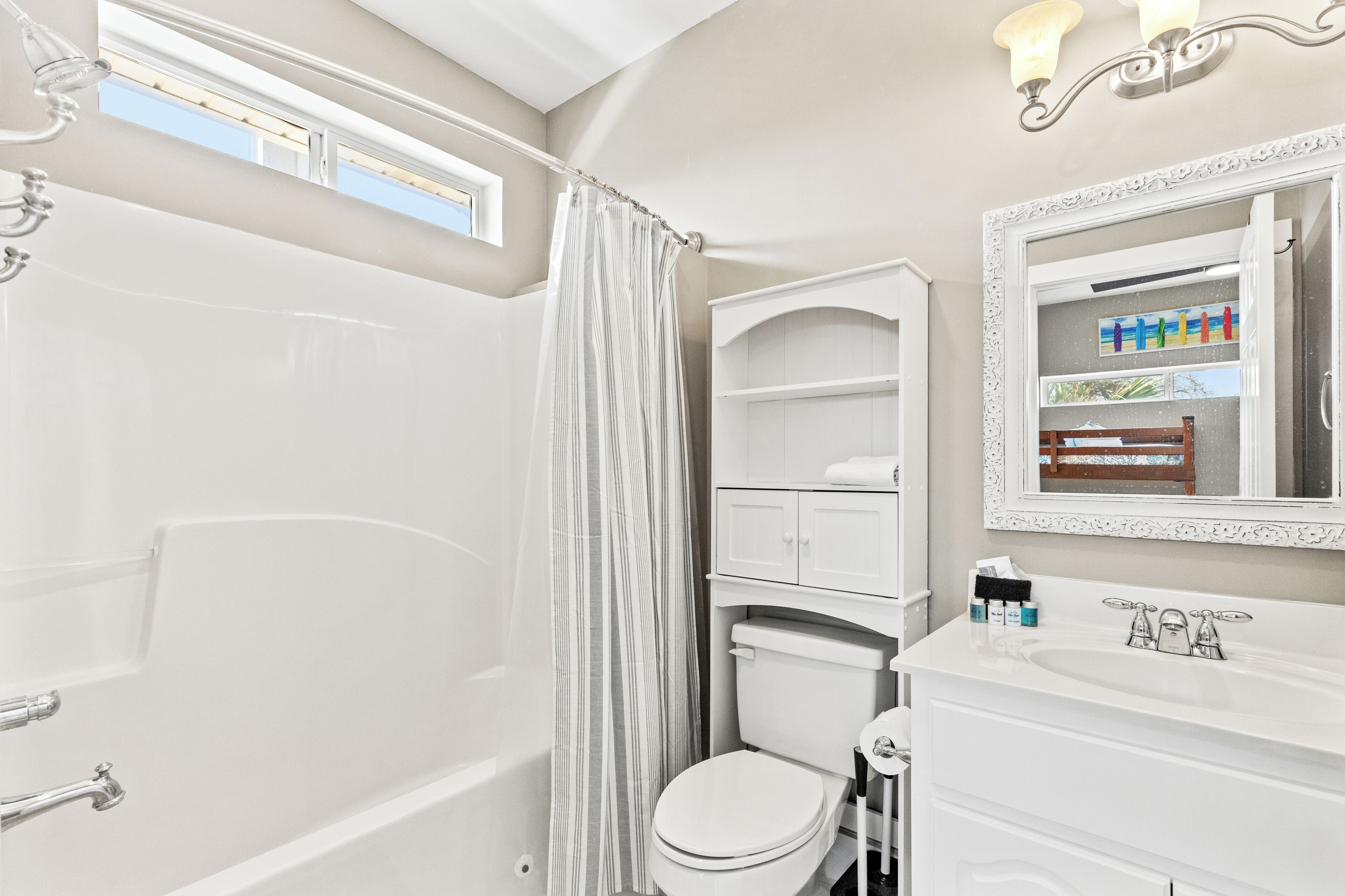 A modern bathroom with a bathtub, toilet, and vanity.