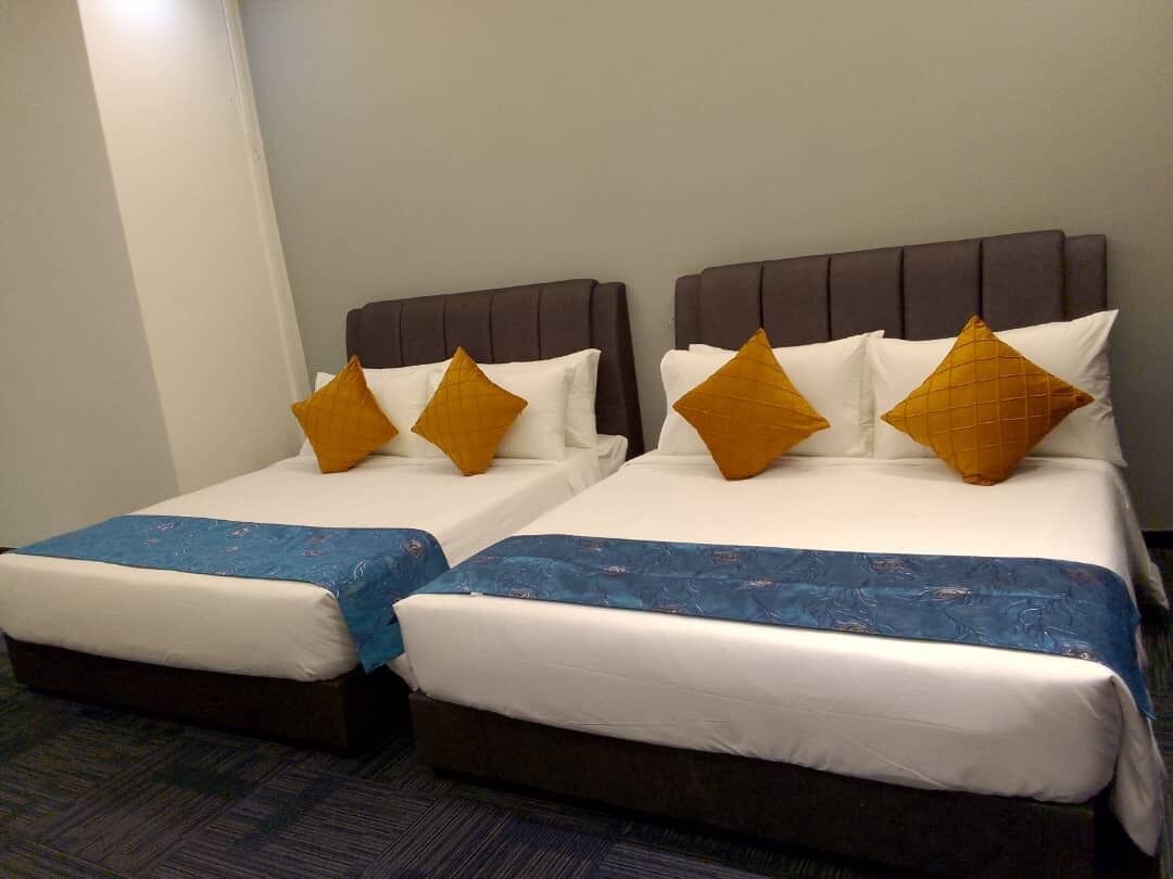 Two twin beds with headboards, white bedding, and blue bed runners.