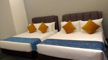 Two twin beds with headboards, white bedding, and blue bed runners.