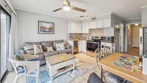 A modern kitchen with white cabinets, a microwave, and a stove. - Beachfront Condo with Communal Pool & Ocean Views! (Hilton Head Island)