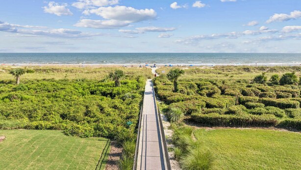 A coastal walkway leading to a beach with a clear sky. - Beachfront Condo with Communal Pool & Ocean Views! (Hilton Head Island)