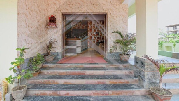 A marble staircase leading to a room with a checkered floor pattern. - DhamStay Hotel Asish Near Sea Beach Puri (Brahmagiri)