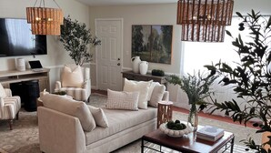 A living room with a sofa, coffee table, and decorative plants. - Marvelous 11-bedroom villa in Escondido (Escondido)