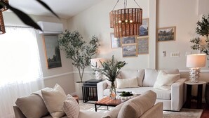 A modern living room with a beige sofa, a coffee table, and a patterned rug. - Marvelous 11-bedroom villa in Escondido (Escondido)