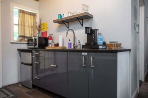 Fridge, microwave, coffee/tea maker, cookware/dishes/utensils