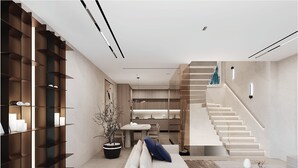 Una sala de estar moderna con una escalera, un comedor y una estantería.