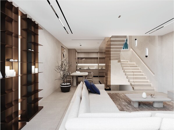 Relax in a comfortable seating area with a sofa and shelving unit, perfect for lounging and socializing.