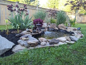 A garden with a pond, rocks, and plants. - Comfortable and elegantly appointed home in this unique small port town. (Port Burwell)