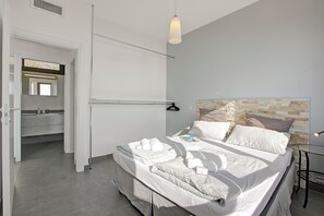 A modern bedroom with a neatly made bed, a bedside table, and a hanging light fixture. - Casa dei Nonni Tremosine 1 with Lake View Terrace, Tremosine, Italy (Tremosine)