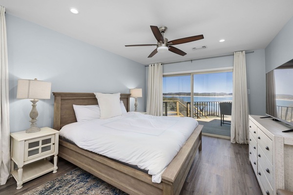 Wake up to breathtaking lake views in this cozy and stylish bedroom!