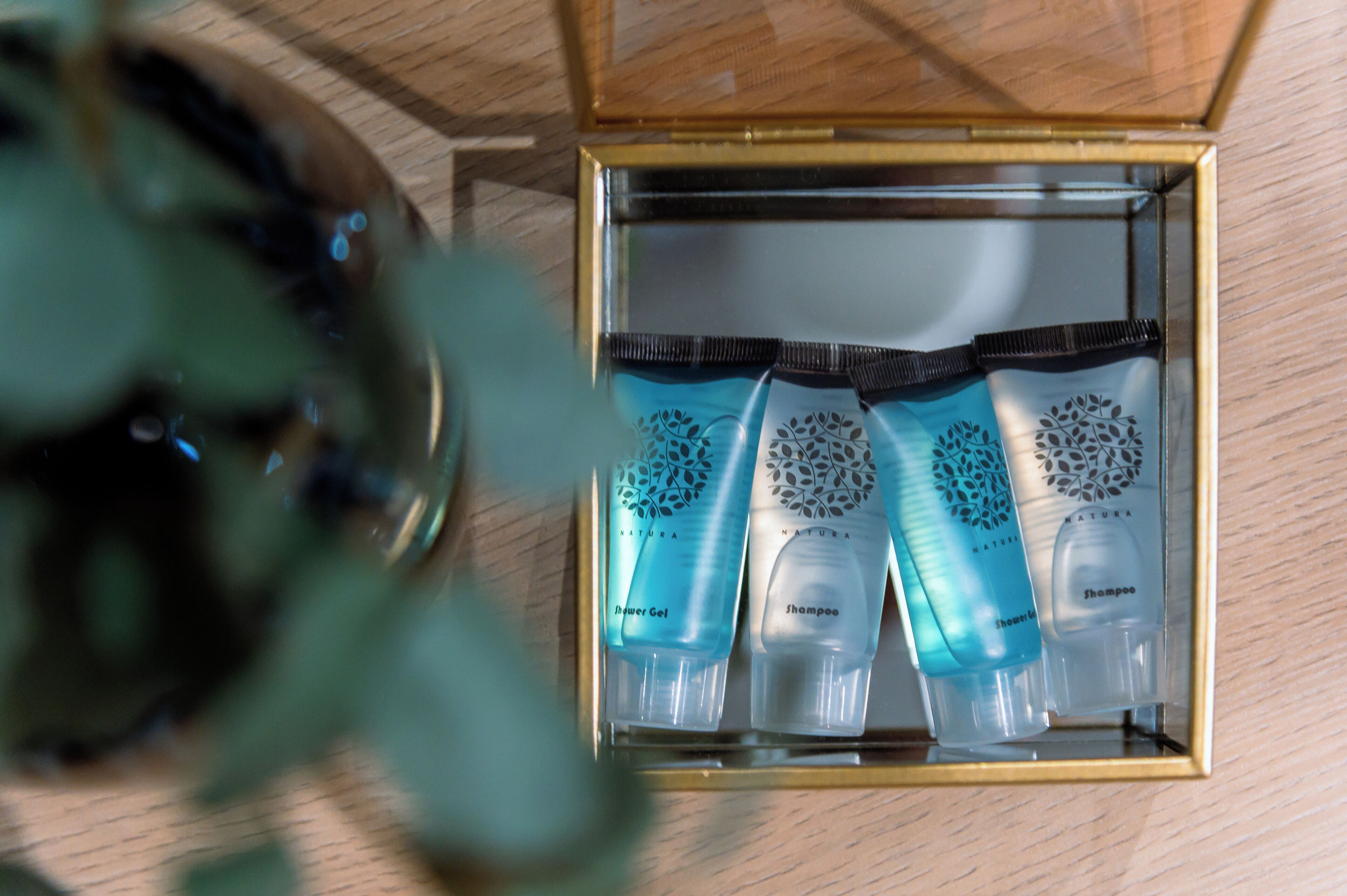 A box containing three bottles of Natura hair care products.