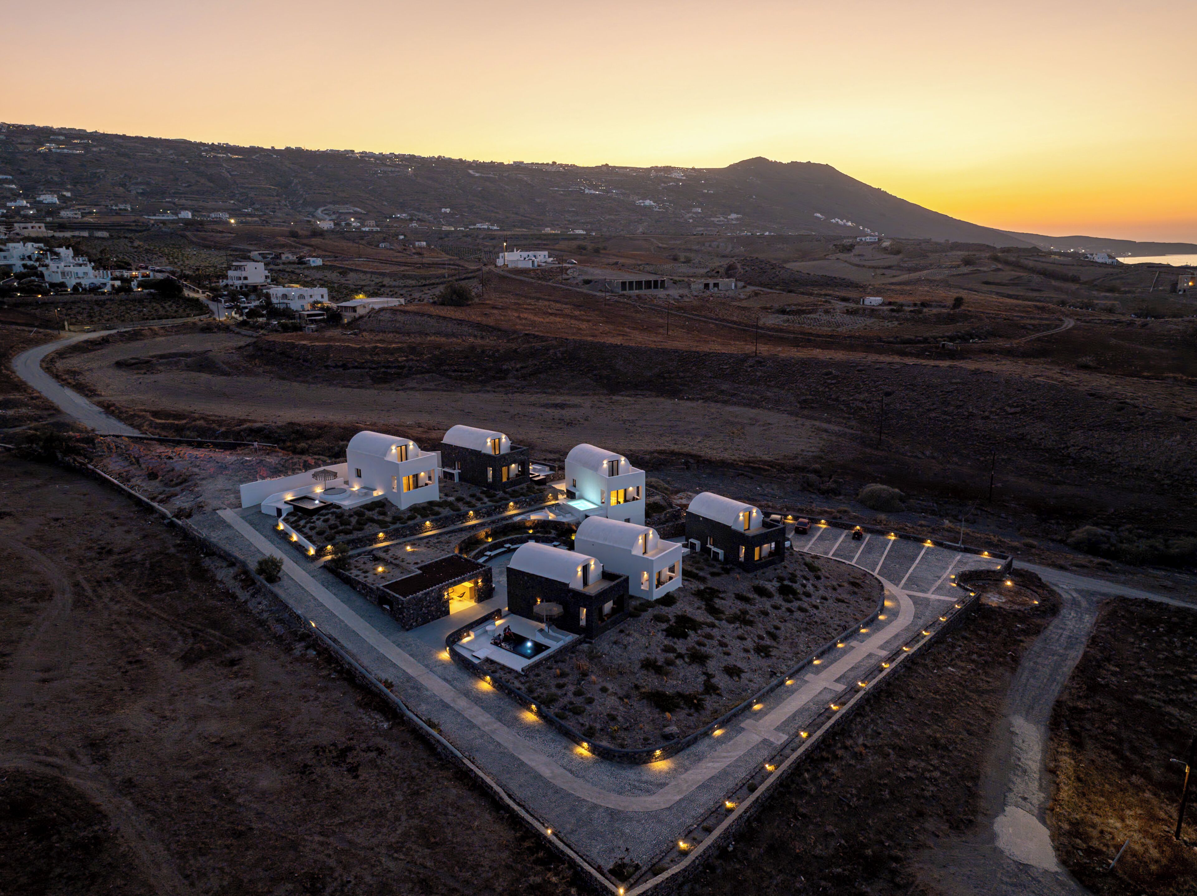 A modern resort with multiple dome-shaped buildings, a central courtyard, and a parking area.