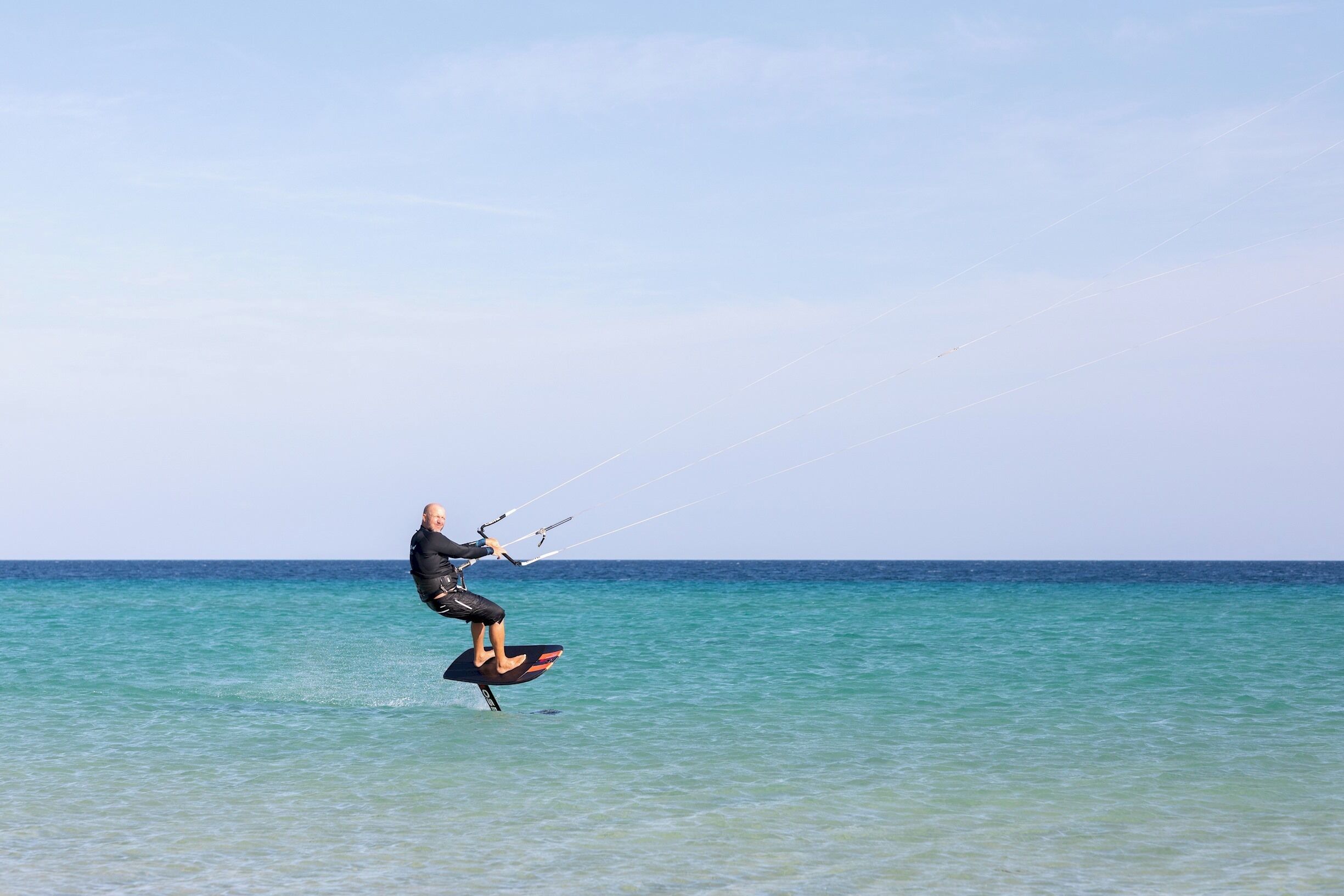 A person kiteboarding in the ocean.