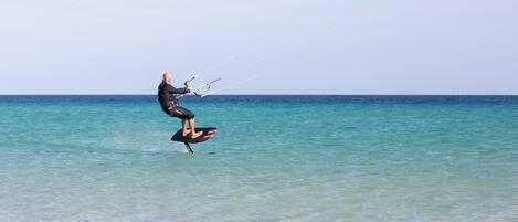 A person kiteboarding in the ocean.