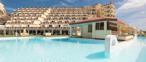 A swimming pool with a building in the background.