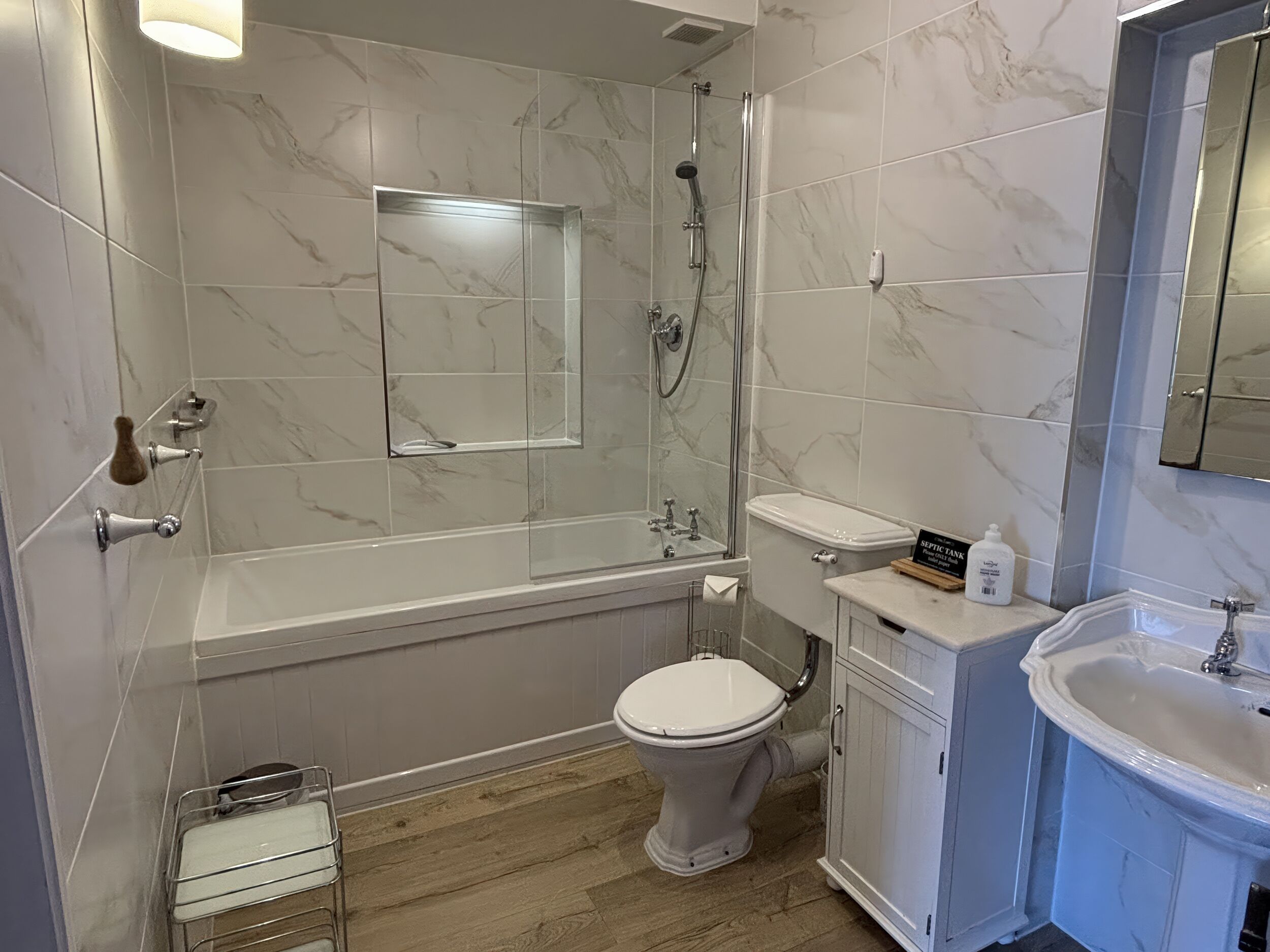 A bathroom with a bathtub, toilet, and sink.