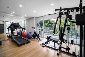 A gym with treadmills, exercise balls, and weight machines.