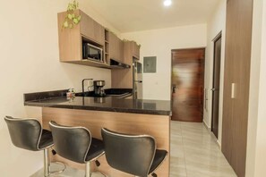 Fridge, stovetop, coffee/tea maker, cookware/dishes/utensils