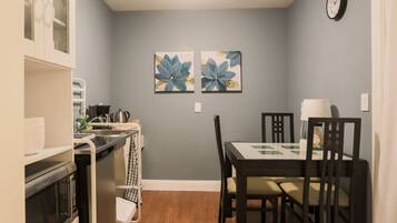 Microwave, coffee/tea maker, cookware/dishes/utensils, dining tables