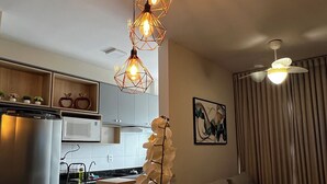A modern kitchen with a dining area. - New and Cozy Apartment! Close to the Mother Bonifácia Park and Santa Rosa Hospital. (Jardim Mariana Cuiabá)