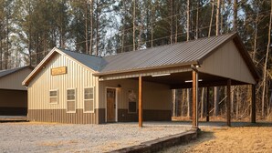 A single-story building with a covered porch and a small entrance.