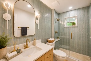 A bathroom with a large mirror, a sink, a toilet, and a shower. - Beautiful French Country Villa wt Pool & Fire-pit in marvelous Austin (Austin)