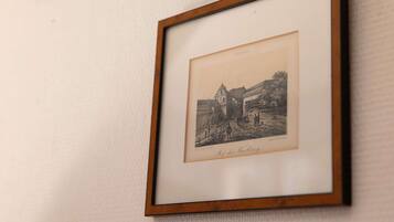 Two framed black and white photographs on a textured wall.