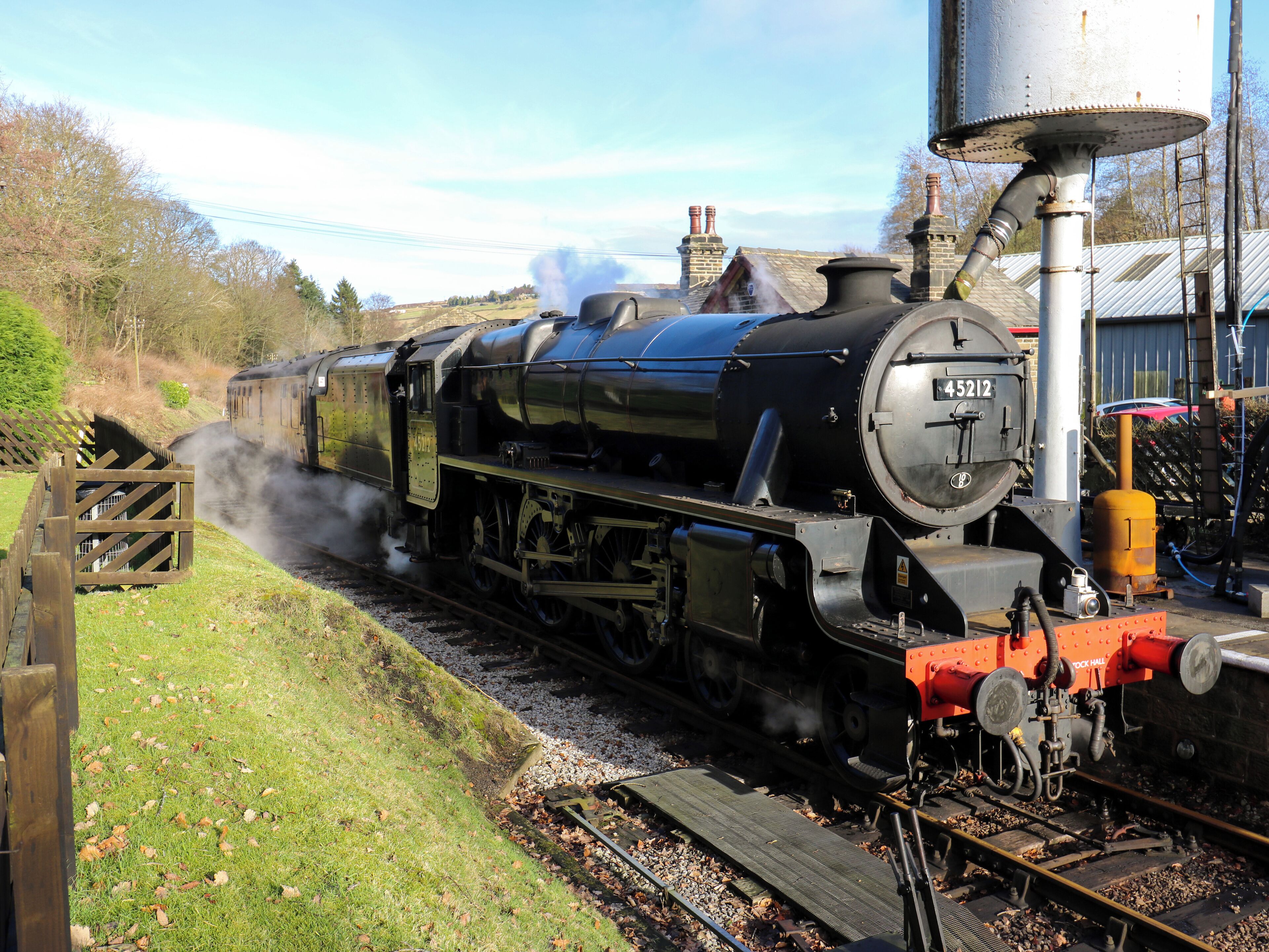 A steam locomotive with the number 45212 on a railway track.