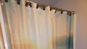 A shower curtain with a landscape design.