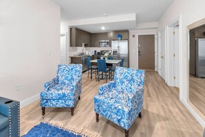 A modern kitchen with a dining area, featuring blue patterned chairs and a coffee bar. - Blue Bliss 2BR 2BTH with FREE Parking, Near NYC & EWR Airport (East Orange)