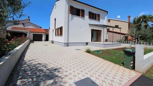 A modern two-story house with a paved driveway, a garage, and a satellite dish. - ROVINJ HOME Studio with Terrace (Rovinj)