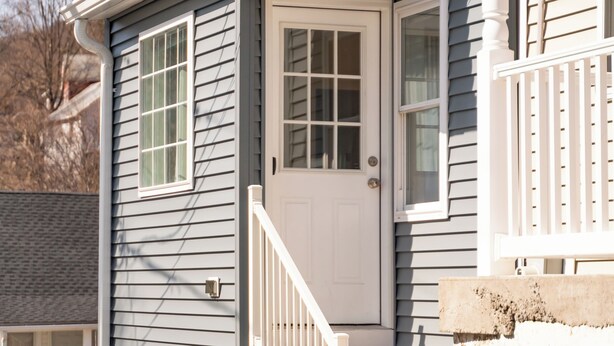 A house with a white front door, a small porch with a white railing, and a window with a green curtain. - Fabulous 3bdrm Home w/parking! (Highland Falls)