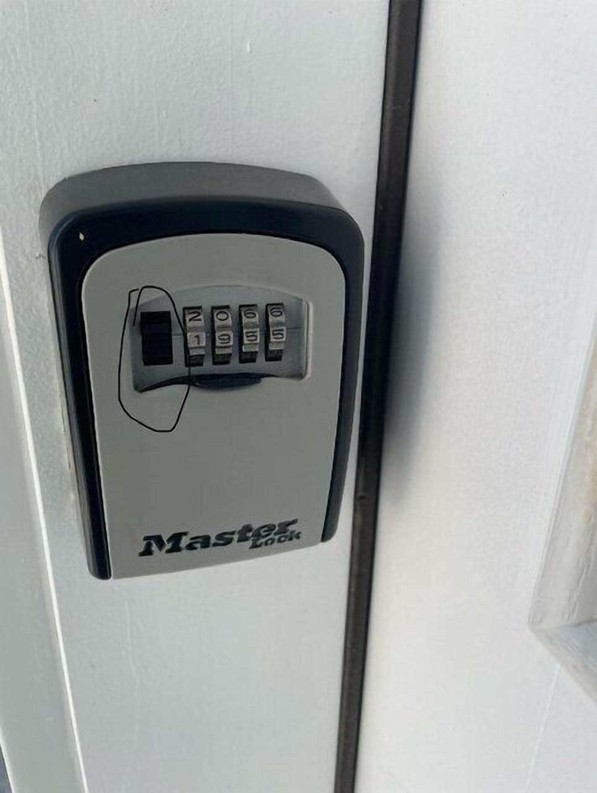 A door with a keypad lock labeled "Master Lock".