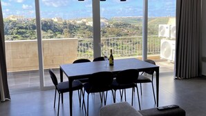 A spacious balcony with a table, chairs, and a sofa. - The Valley Collection - Suite B23 (Ix-Xagħra)