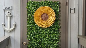 A door with a welcome sign, a house number, and a mailbox.