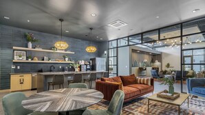 A modern interior with a dining area, sofa, and kitchen. - King Bed Comfort | Free Parking | UPMC, Pitt & CMU (Pittsburgh)